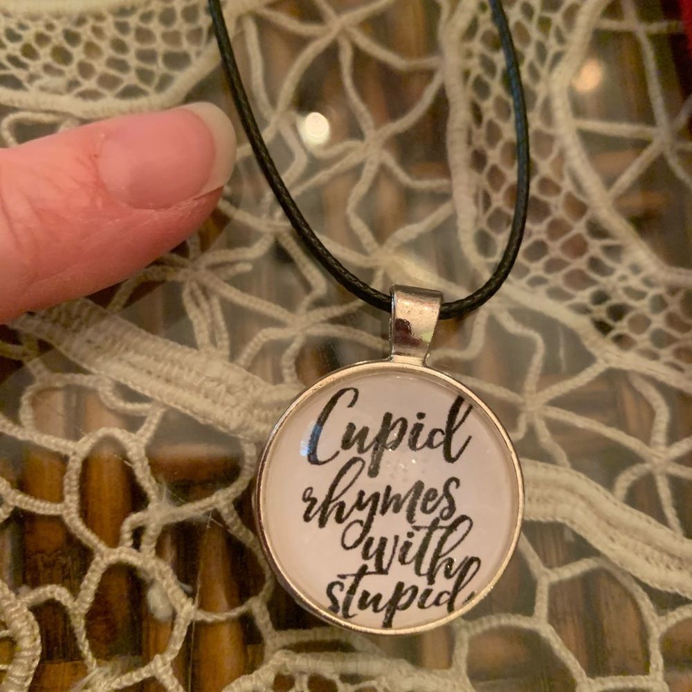 Cupid rhymes with Stupid -silvertone pendant with vegan leather cord NEW